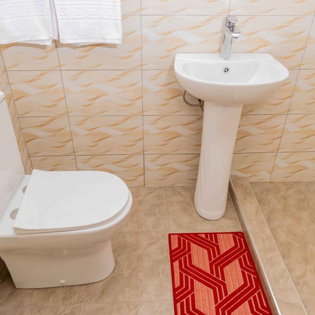 Private bathroom with fresh towels and a pedestal basin