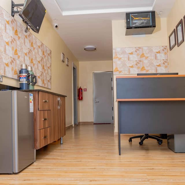 Inside the reception, with the front desk and a kitchenette